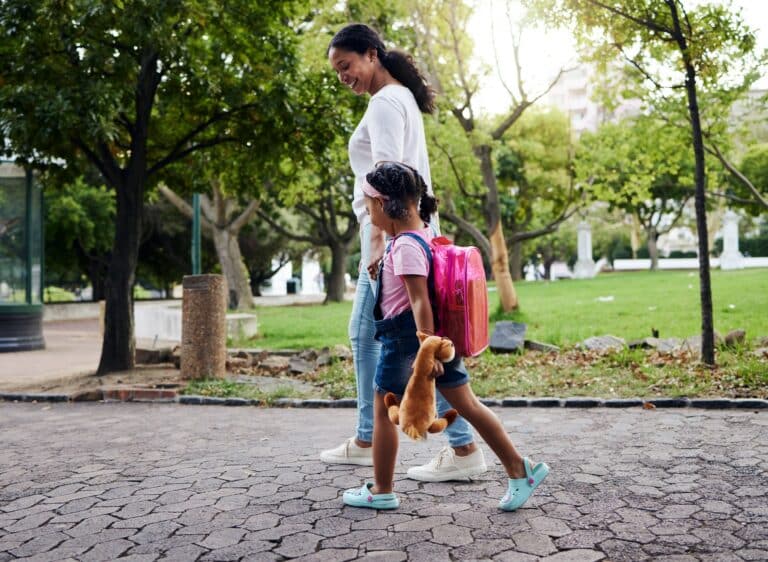 mom and daughter walking to school